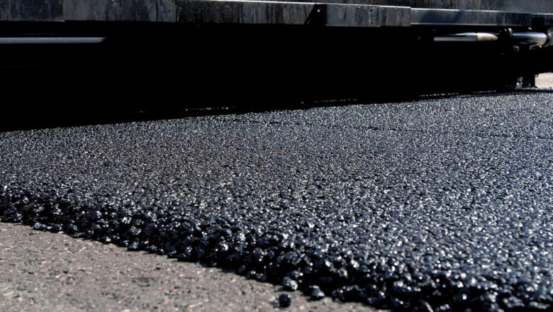 Asphalt is a tar-like black substance that is commonly used to pave roads and fix potholes.